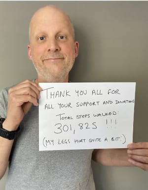 Joe holding a sign to say thank you